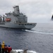 Sailors aboard the USS Howard conduct a replenishment-at-sea with USNS Yukon in the Philippine Sea