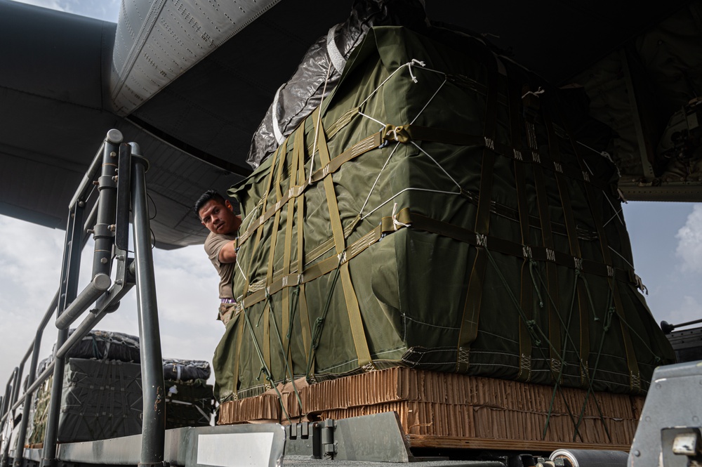 Airmen load AFCENT C-130s with humanitarian aid bound for Gaza