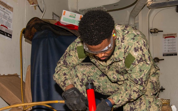 USS Carl Vison (CVN 70) Sailor Conducts Preventative Maintenance