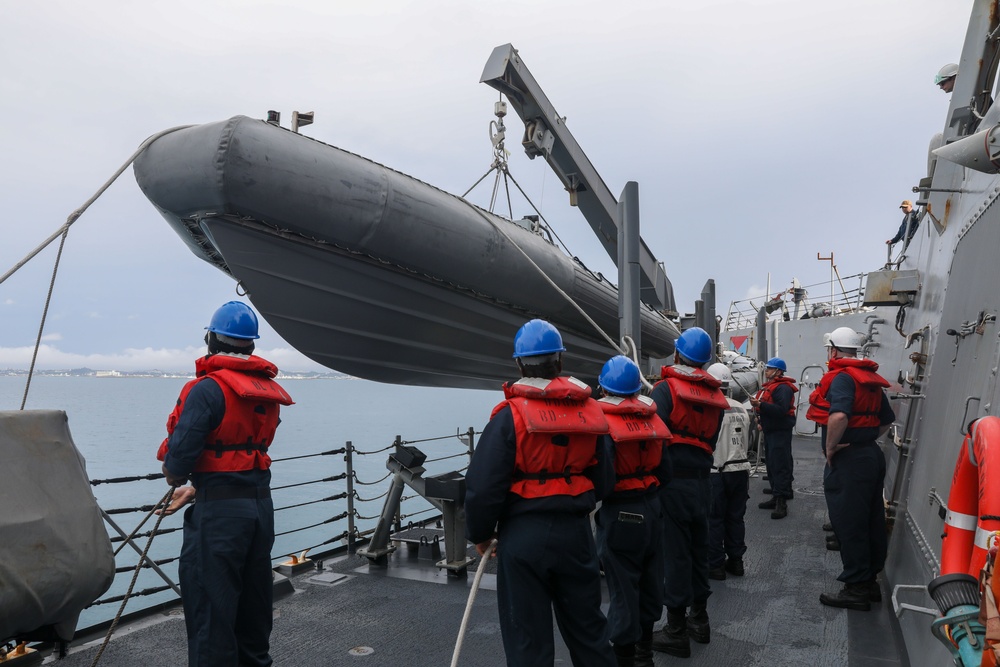 Sailors aboard the USS Howard conduct boat operations in Okinawa, Japan