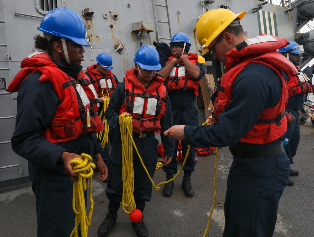 Sailors aboard the USS Howard prepare the heaving lines in Okinawa, Japan