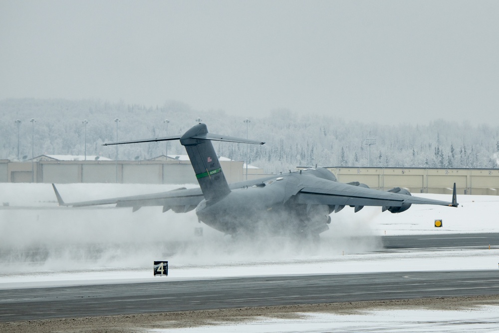 DVIDS - Images - JBLM C-17 takes off from JBER during snowfall