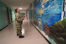 Sailor volunteers to paint murals at the Huntington Hall Naval Berthing Facility [Image 3 of 5]