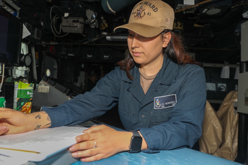 Sailors aboard the USS Howard stand watch in the North Pacific Ocean