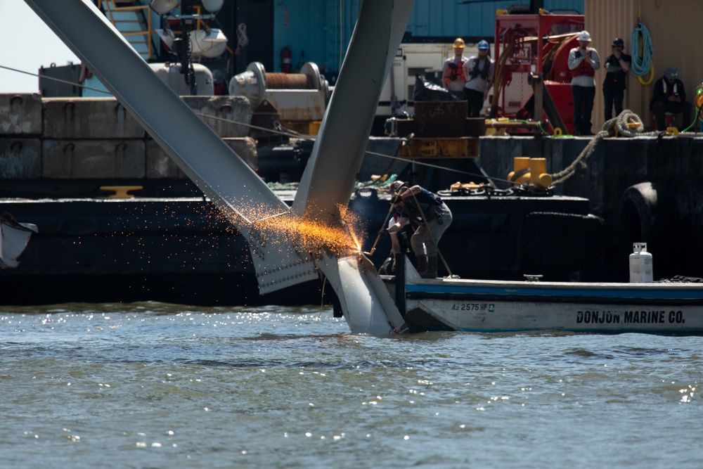 Key Bridge Response 2024 Unified Command salvors move a large piece of supporting steel from the collapsed Francis Scott Key Bridge.