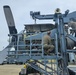 Airmen install propeller on jet engine test stand
