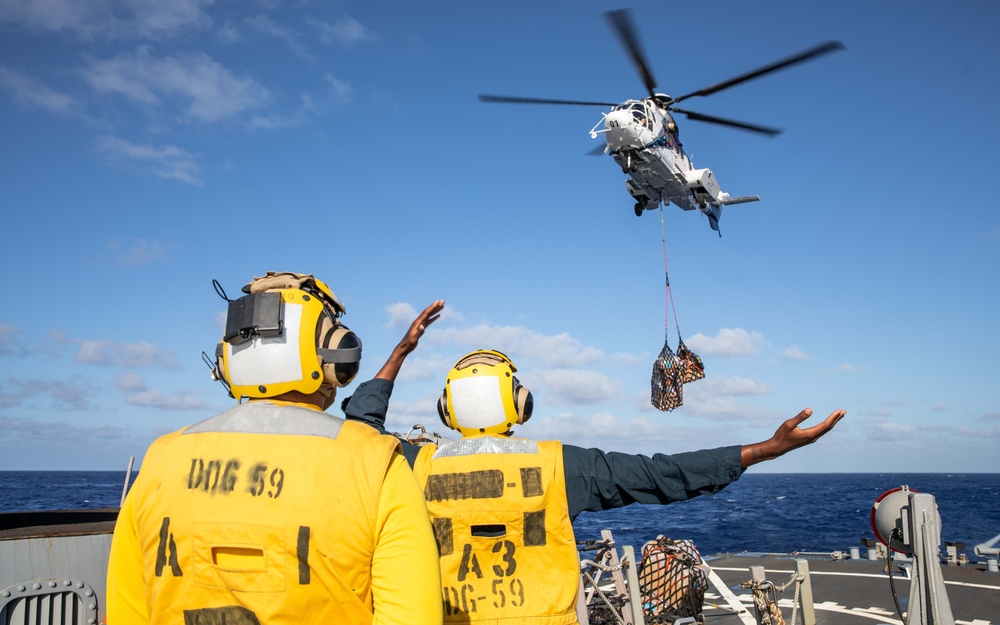 USS Russell (DDG 59) conducts a vertical replenishment with USNS Wally Schirra (T-AKE-8)