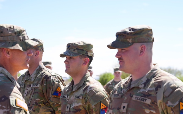 Command Sgt. Maj. James Light Presents the Army Achievement Medal to Best Tank Crew