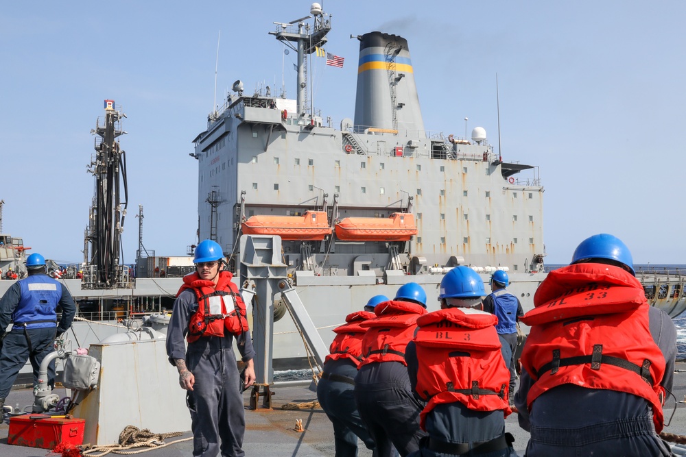 Sailors aboard the USS Howard conduct a replenishment-at-sea with USNS John Ericson in the Philippine Sea