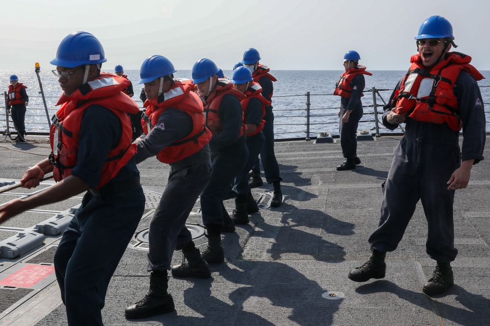 Sailors aboard the USS Howard conduct a replenishment-at-sea with USNS John Ericson in the Philippine Sea