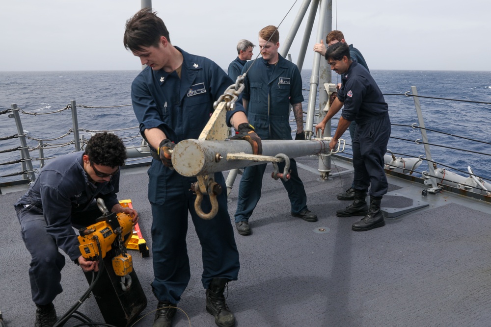 Sailors aboard the USS Howard prepare for a torpedo upload in the Philippine Sea