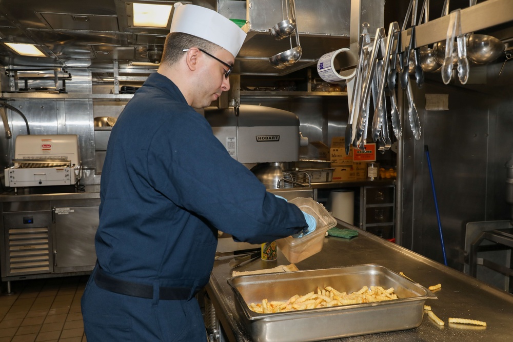 Sailors aboard the USS Howard prepare lunch for the crew in the Philippine Sea