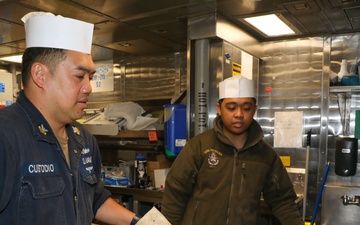 Sailors aboard the USS Howard prepare lunch for the crew in the Philippine Sea
