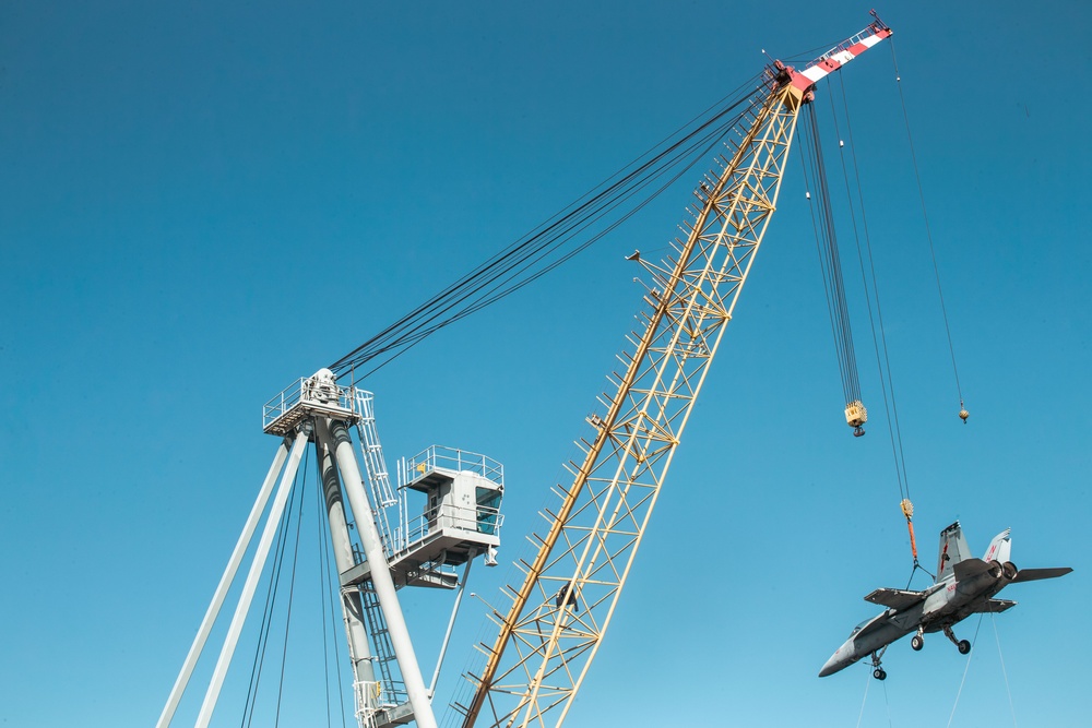 Training Aircraft Lifted Via Crane Aboard Ford