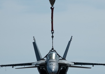 Training Aircraft Lifted Via Crane Aboard Ford