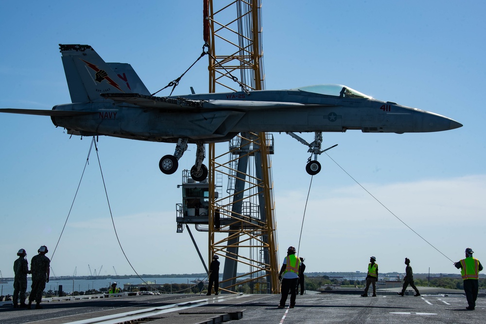 Training Aircraft Lifted Via Crane Aboard Ford