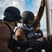 Coast Guard members load a gun
