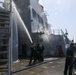 Sailors aboard the USS Howard conduct a freshwater wash down in the North Pacific Ocean