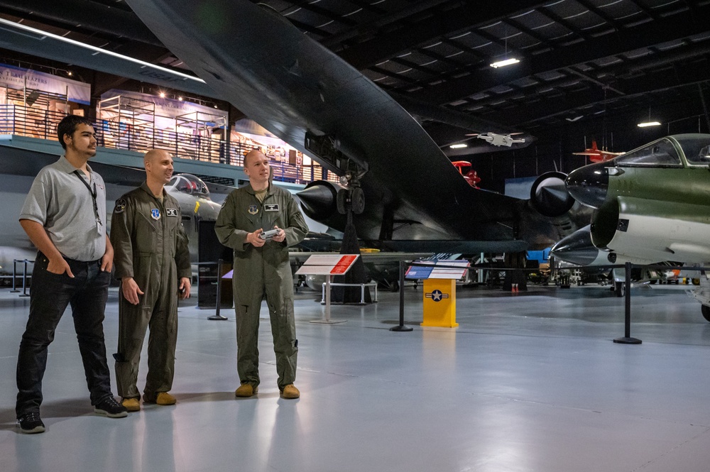 Photo of 116th Air Control Wing members working with Atlanta students in flight simulation, aerospace operations, and drone operation competition events.