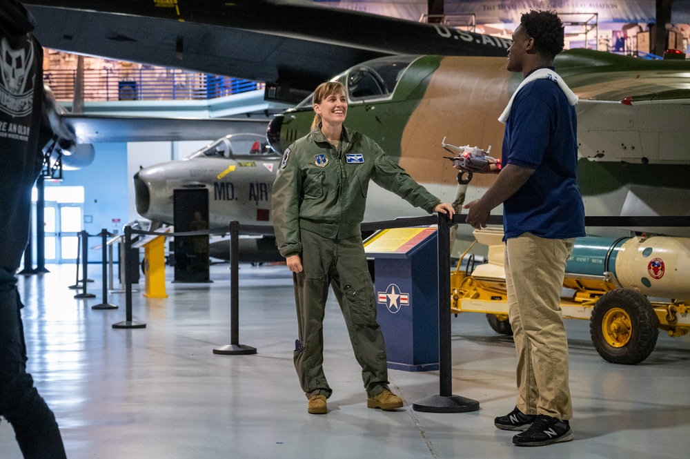 Photo of 116th Air Control Wing members working with Atlanta students in flight simulation, aerospace operations, and drone operation competition events.
