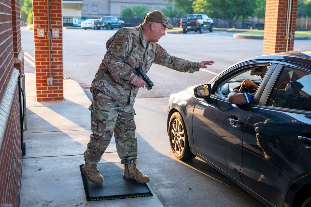 Photo of 116th Air Control Wing leadership greeting Team Robins members entering base during unit training assembly.