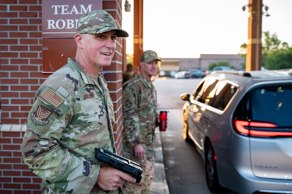 Photo of 116th Air Control Wing leadership greeting Team Robins members entering base during unit training assembly.