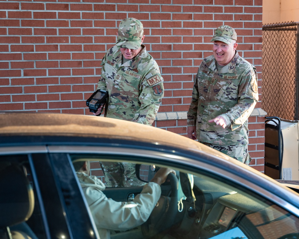 Photo of 116th Air Control Wing leadership greeting Team Robins members entering base during unit training assembly.