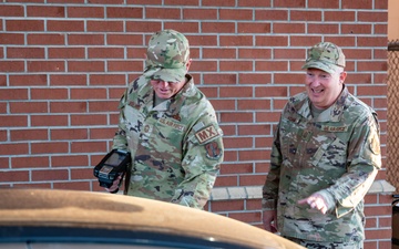 Photo of 116th Air Control Wing leadership greeting Team Robins members entering base during unit training assembly.