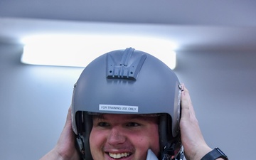 Pilot for a day Corey Johnson, Jr, tries on a flight helmet