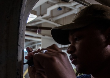 USS Ronald Reagan (CVN 76) Sailors preform maintenance on ship systems