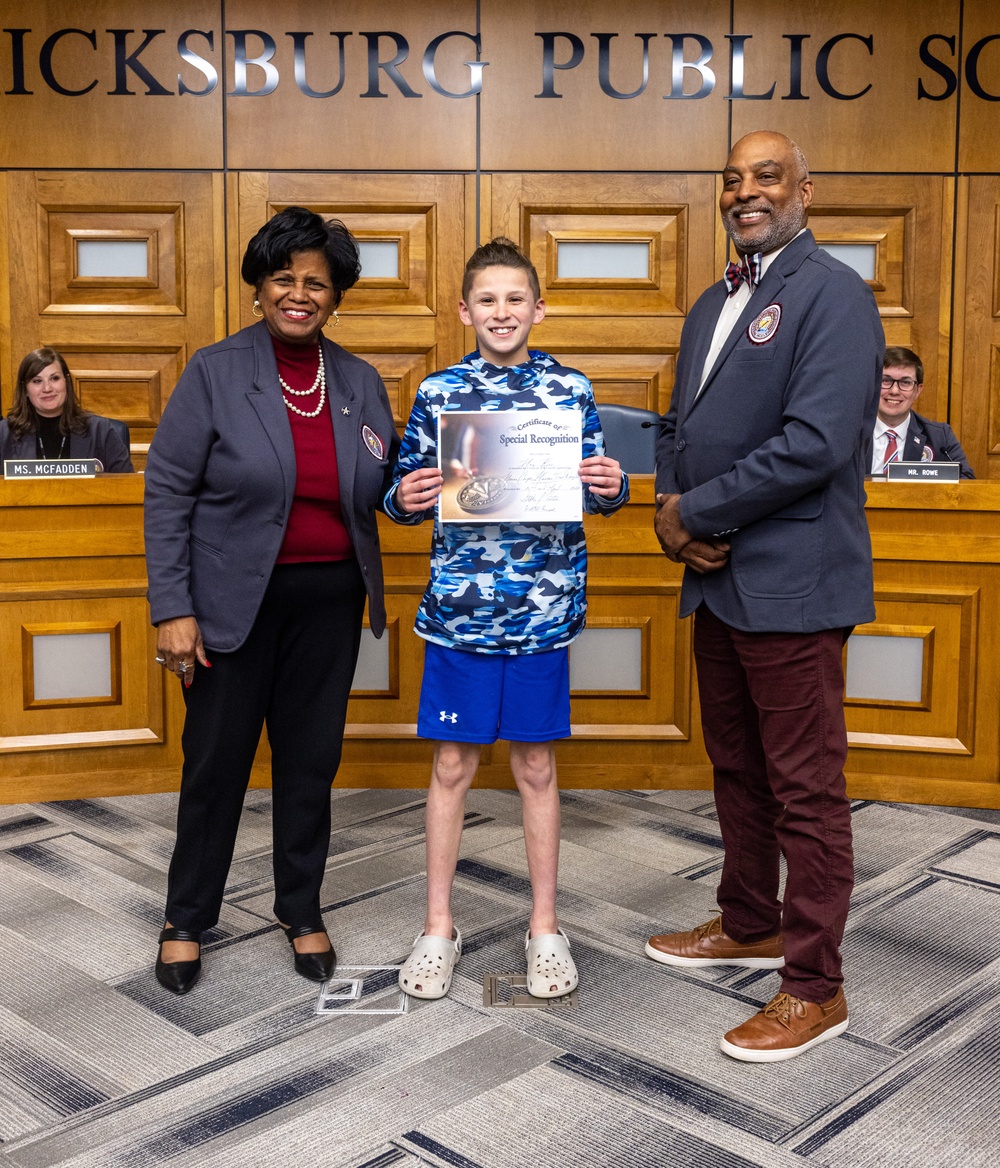 Fredericksburg City Public Schools presents Col. Brooks with the 2024 Fredericksburg City Public Schools resolution for the Month of the Military Child
