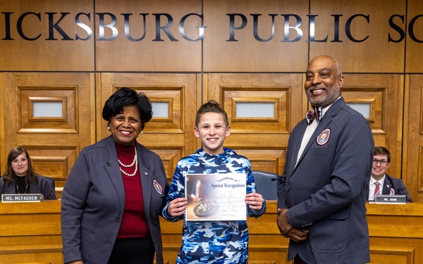 Fredericksburg City Public Schools presents Col. Brooks with the 2024 Fredericksburg City Public Schools resolution for the Month of the Military Child