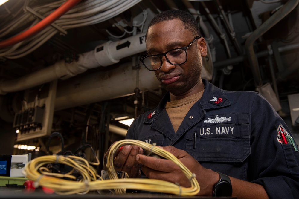Electrician’s Mate conducts maintenance on a catapult rotary panel