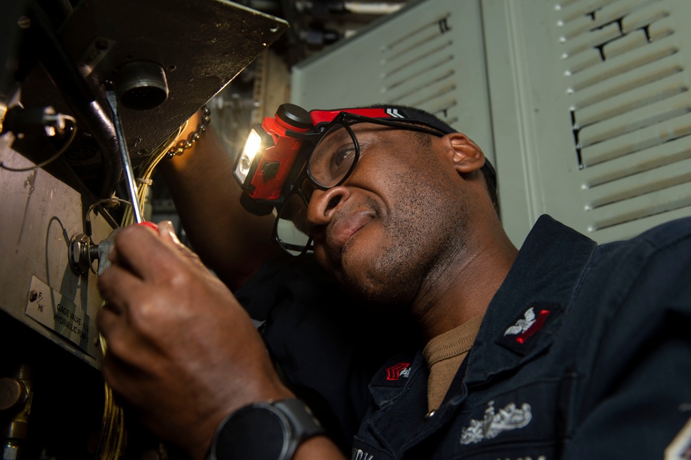 Electrician’s Mate conducts maintenance on a catapult rotary panel