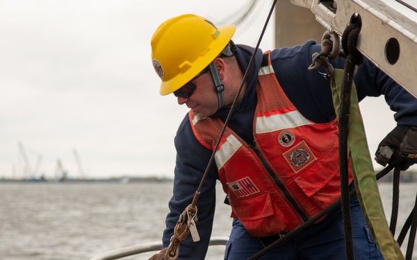 U.S. Coast Guard personnel deploy buoys marking Fort Carroll temporary alternate channel