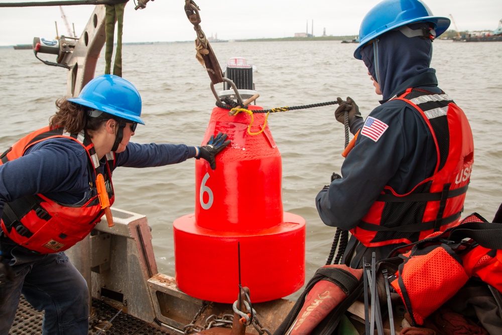 U.S. Coast Guard personnel deploy buoys marking Fort Carroll temporary alternate channel