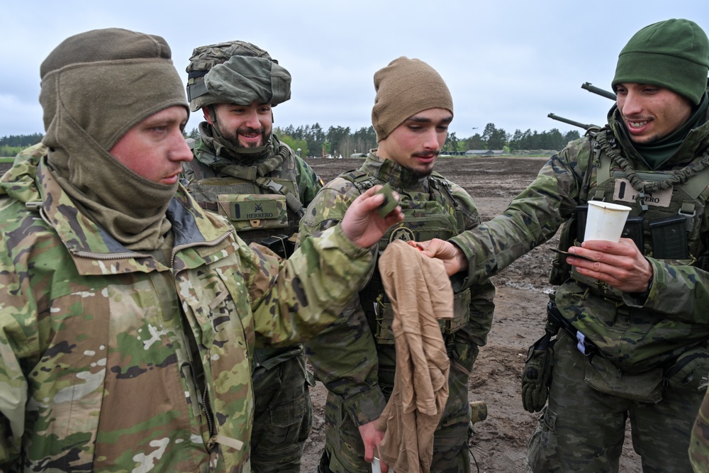 Saber Strike 24: U.S. Soldiers and Spanish Armed Forces Soldiers exchange items