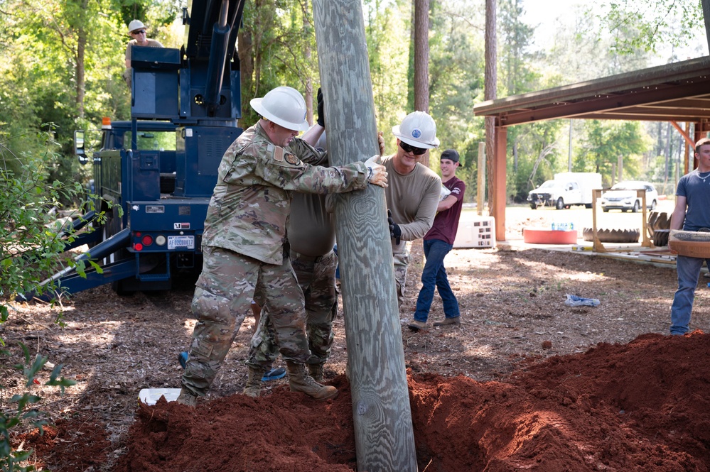 Photo of U.S. Airmen Constructing Obstacle Course at Perry High School