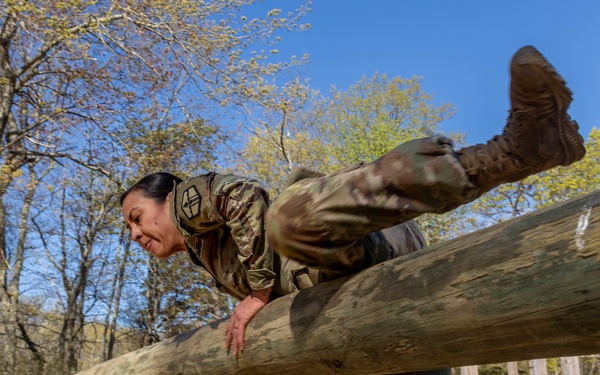 1st Lt. Jessica Romero hurdles over an obstacle