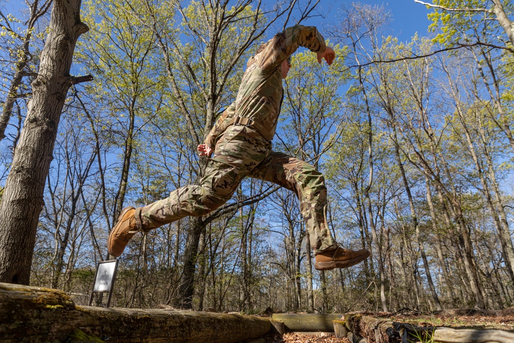 Sgt. Thomas Hunt jumps over a pit