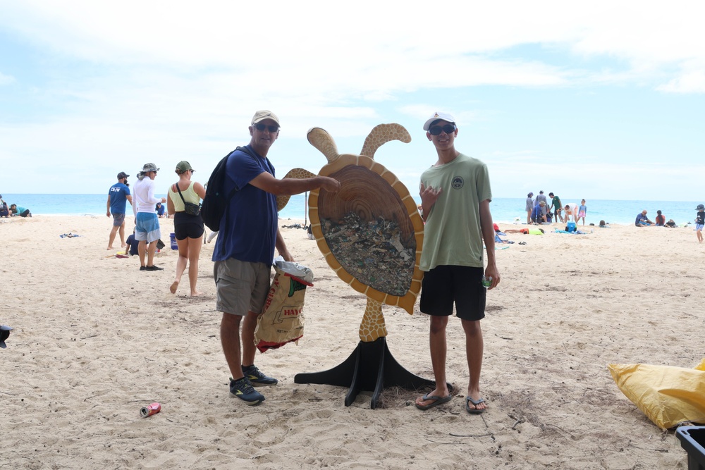 Tide-ying Up!: U.S. service members alongside members of the local community participate in a beach clean-up at MCTAB