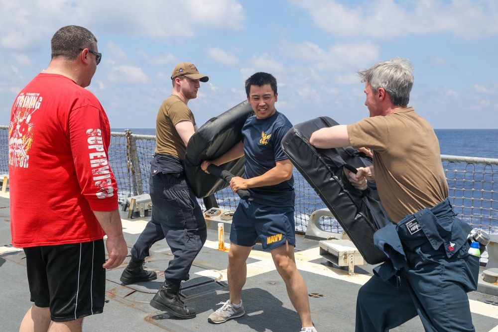 Sailors aboard the USS Howard conduct a sea contamination exercise in the South China Sea