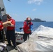 Sailors aboard the USS Howard conduct a vertical replenishment-at-sea with the USNS Wally Schirra in the South China Sea