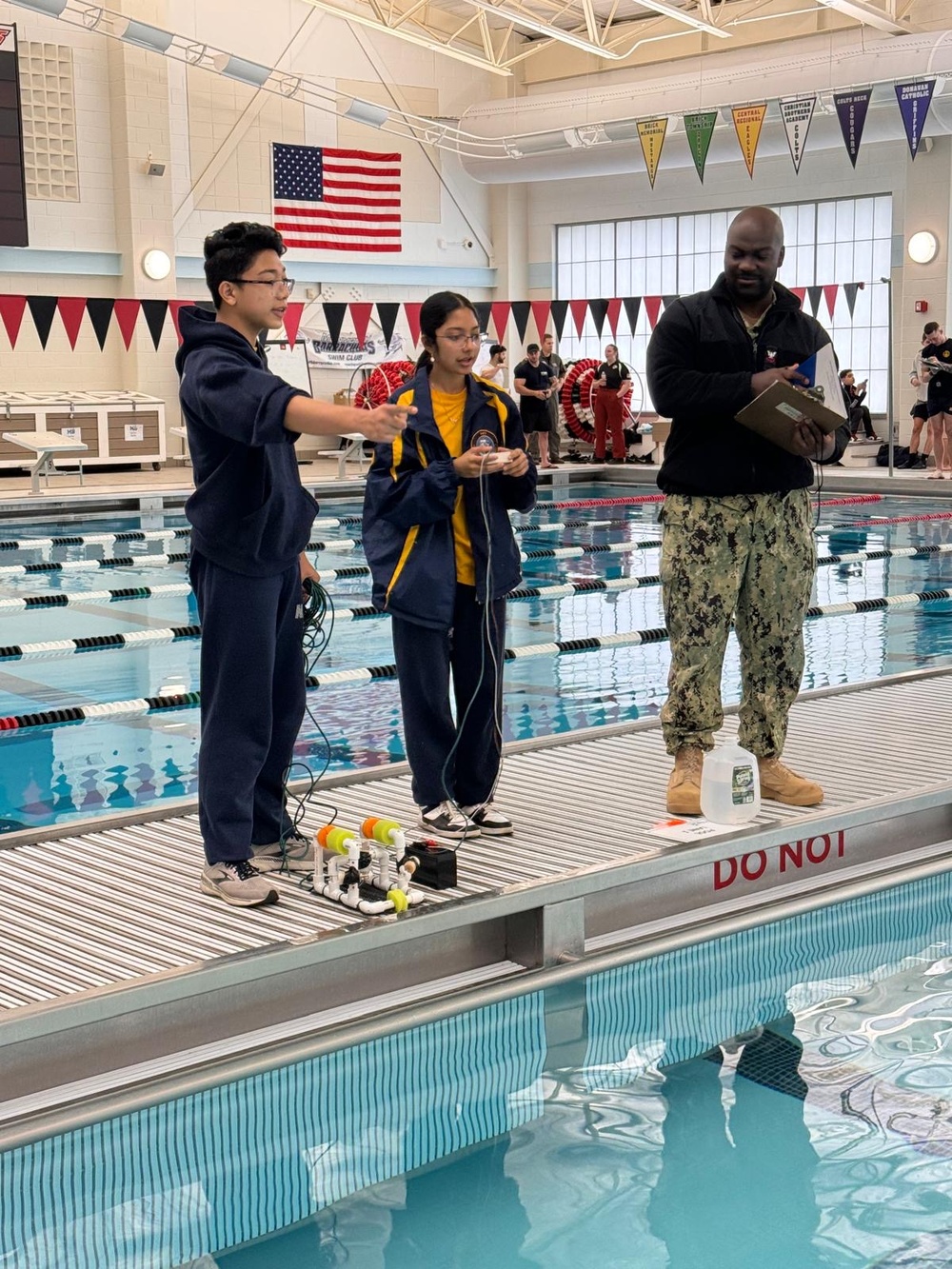 An NTAG Sailor assists students at NJ/NY Regional SeaPerch Competition