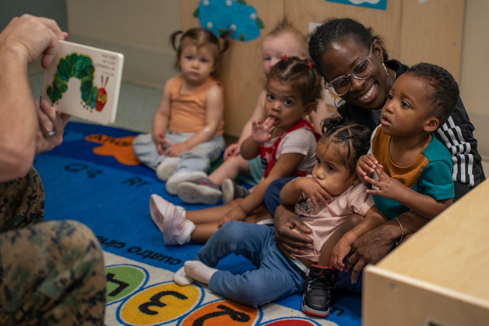Volunteers read at CDC for the Month of the Military Child