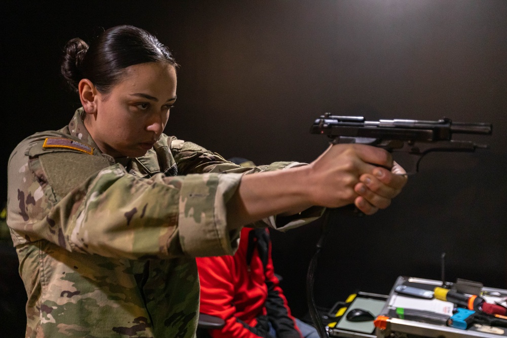 1st Lt. Brainna Mirmina fires a simulation pistol