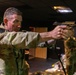 Capt. Zachary Grimes fires a simulation pistol