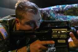 Staff Sgt. Gavin Hopler fires a simulation rifle [Image 8 of 8]