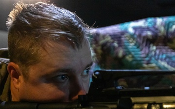 Staff Sgt. Gavin Hopler fires a simulation rifle
