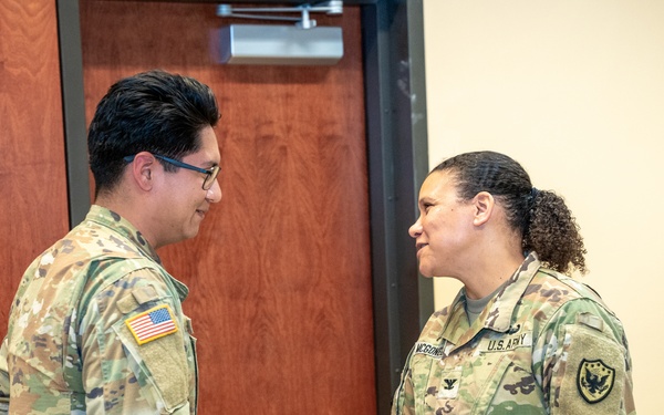 Spc. Taipe Receives Coin From Col. McGonegal